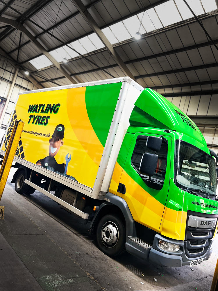 Rigid truck in yellow and green fleet livery